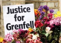  ??  ?? Flowers and messages left by well-wishers in tribute to the victims of the Grenfell Tower block are pictured near the scene of the fire in North Kensington, west London on Thursday. (AFP)