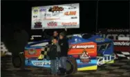  ??  ?? Ryan Watt raises the winner’s check alongside son Logan and wife Leslie after winning the Mods at the Madhouse event at Grandview Speedway on Oct. 13.