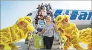  ?? WU WEI / FOR CHINA DAILY ?? Tourists from Russia arrive at Sanya Phoenix Internatio­nal Airport in Hainan province.