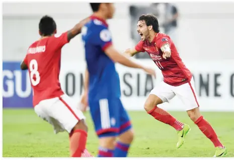  ??  ?? Ricardo Goulart, right, of Guangzhou Evergrande, celebrates with teammate Paulinho, left, after scoring against Suwon Samsung Bluewings during their AFC Champions League group stage football match in Guangzhou, in China's Guangdong province, on...