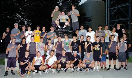  ?? MIKE CAPSHAW ENTERPRISE-LEADER ?? Prairie Grove football players are all smiles while posing for a photo around the Gorilla statue outside of Carnie Smith Stadium on the campus of Pitt State University in Pittsburg, Kan. The Tigers were there for Coach Tim Beck’s Team Camp from June 9-11.