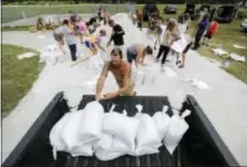  ?? DAVID GOLDMAN - THE ASSOCIATED PRESS ?? Ryan Kaye loads sandbags into his truck at a makeshift filling station provided by the county as protection ahead of Hurricane Irma, Friday, in Palm Coast, Fla.