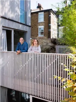  ??  ?? Tikari Works’ founders Ty and Nicola Tikari stand outside their London home, with its distinctiv­e timber and brick exterior