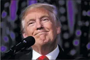  ?? The Associated Press ?? TRUMP: In this Nov. 9, 2016, photo, President-elect Donald Trump smiles as he arrives to speak at an election night rally, Wednesday in New York. Donald Trump enters the White House on Jan. 20 just as he entered the race for president: defiant,...