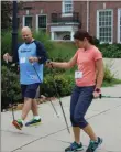  ?? MEDIANEWS GROUP FILE PHOTO ?? Lucie Bergeyova, on the right, teaches a man the technique for Nordic Walking during a seminar at the Pottstown Middle School.