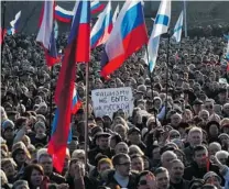  ?? VASILIY BATANOV/ AFP/ GETTY IMAGES ?? Protesters gather, some waving Russian fl ags, in the southern Ukrainian city of Sevastopol, the main base of the Russian Black Sea Fleet, on Sunday.