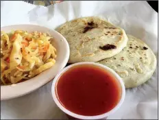  ?? Arkansas Democrat-Gazette/ERIC E. HARRISON ?? Two papusas — one filled with cheese, the other with a cheese-and-chicken mixture — are listed among the starters on the menu at El Pollo Rico, but with a bowl of spicy slaw, they’re filling enough to be a full meal.