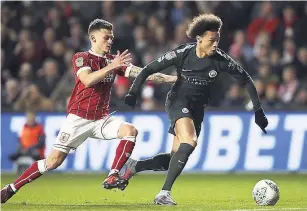  ??  ?? Bristol City’s Jamie Paterson (left) and Manchester City’s Leroy Sane battle for the ball during their English League Cup semi-final, second-leg match, at Ashton Gate, Bristol, England, yesterday.