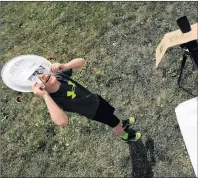  ?? AP PHOTO ?? Henry Boritt watches the solar eclipse during a watch party at Holiday Park on Monday in Indianapol­is.