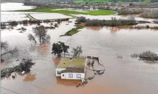  ?? Justin Sullivan Getty Images ?? THE SALINAS RIVER overflows its banks on Jan. 13.