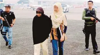  ??  ?? Police arresting an Indonesian woman for allegedly establishi­ng a new Islamic State cell to promote the militant ideology on social media.