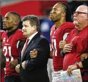 ?? ROSS D. FRANKLIN / ASSOCIATED PRESS 2017 ?? Arizona Cardinals cornerback Patrick Peterson (from left), President Michael Bidwill, wide receiver Larry Fitzgerald and head coach Bruce Arians stand during the national anthem before a September game against the Dallas Cowboys last year.