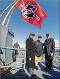  ?? AP ?? Jerry Bruckheime­r (from left), honorary captain Bretton Chitwood (17) and CEO of the Seattle NHL franchise Tim Leiweke stand on top of the Space Needle during a season ticket drive. The NHL awarded Seattle a franchise that will begin play in 2021.