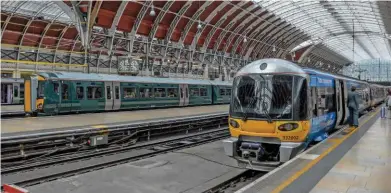  ?? EIKI SEKINE. ?? The first Electrosta­r for Great Western Railway (387130) stands in London Paddington during testing on the Great Western Main Line on August 1 2016, while Heathrow Express 332002 waits with a train for Heathrow Airport.