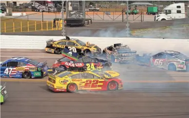  ?? MARVIN GENTRY/USA TODAY SPORTS ?? NASCAR Cup Series driver Joey Logano (22) crashes along with William Byron (24), Ryan Preece (47), Austin Theriault (51) and Joey Gase (66) during the continuati­on of the 1000Bulbs.com 500 on Monday.