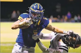  ?? Wally Skalij Los Angeles Times ?? AIDEN RAMOS of Bishop Amat stiff-arms a Murrieta Valley defender in the fourth quarter to gain a few of his 303 yards rushing. Ramos set a school record by scoring seven touchdowns.