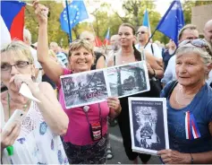  ??  ?? Women hold placards with photos from the Soviet-led invasion during a demonstrat­ion in 1968 in front of the Russian embassy in Prague. — AFP photo