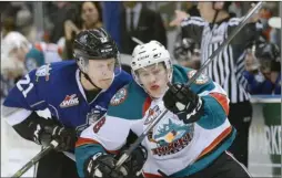  ?? Daily Courier file photo ?? Kelowna Rocket Jack Cowell and Victoria Royal, Carter Folk collide while chasing after the puck during a game in March.