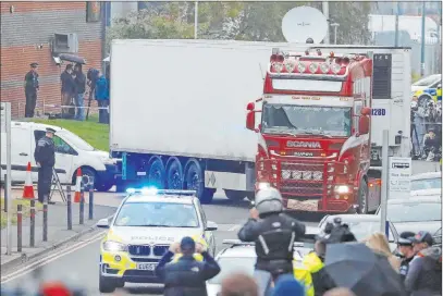  ?? Alastair Grant The Associated Press ?? Police escort a truck that contained 39 bodies as they move it Wednesday from an industrial estate in Thurrock, south England.