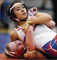  ??  ?? Marysville’s Laila Oribello, top, and Lakota West’s Grace Hicks compete in a 121-pound match during the Pioneer Classic at Olentangy Orange on Jan. 4.