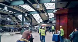  ?? — AP ?? Hoboken train station lies in a heap of broken concrete and twisted metal after a train crashed into it on Thursday morning.