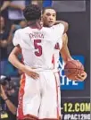  ?? Ethan Miller Getty Images ?? STANLEY JOHNSON of Arizona hugs Brandon Ashley.