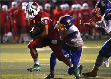  ?? RECORDER PHOTO BY CHIEKO HARA ?? Lindsay High School's Ethan Duran carries the ball to score the team's first touchdown Friday, during the first half against Exeter High at Frank Skadan Stadium in Lindsay.