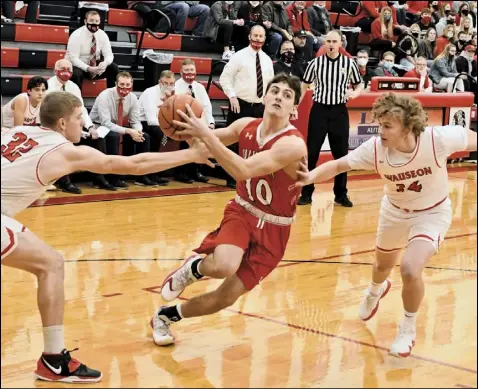  ?? Photo by John Zwez ?? Braeden Goulet of Wapakoneta bends his way between Isaac Wilson (left) and Kolton degroff of Wauseon during Friday’s division II sectional final. See more photos at wapakdaily­news.com.