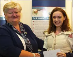  ??  ?? Sarah Logan of the Credit Union education committee making the presentati­on to St Mary’sSecondary School student Emma Ryan from New Ross.
