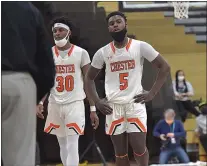  ?? PETE BANNAN — MEDIANEWS GROUP ?? Chester seniors Karell Watkins, left, and Isaiah Freeman walk off the court during a fourth-quarter timeout Monday. They’d leave the court for the final time as Clippers in an 84-63loss to Archbishop Ryan in the PIAA Class 5A semifinals.