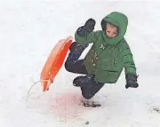  ?? [PHOTO BY BILL GREEN/THE FREDERICK NEWS-POST VIA AP] ?? Reid Claney, 6, flies off his sled Wednesday after trying a snow jump at a popular sledding spot in Frederick, Md. The fourth nor’easter in three weeks has dumped more than a foot of snow in some places.