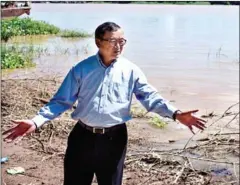  ?? POST STAFF ?? Former CNRP President Sam Rainsy stands along the Bassac River outside his home in Phnom Penh’s Chak Angre Leu commune in 2015.