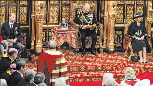  ?? Alastair Grant The Associated Press ?? Prince Charles sits next to the queen’s crown Tuesday during the opening of Parliament at the Palace of Westminste­r in London. Queen Elizabeth II did not attend. Prince William is seated at second left, and Camilla, the Duchess of Cornwall, is seated at right.