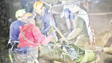  ??  ?? Rescue personnel work at the Tham Luang cave complex. — Reuters photo