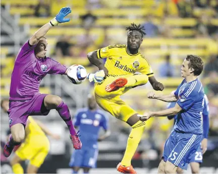  ?? ELI HILLER/THE ASSOCIATED PRESS ?? Crew SC forward Kei Kamara, centre, leaps for the shot as Impact goalkeeper Evan Bush, left, and defender Wandrille Lefèvre try to stop him during their game at Mapfre Stadium in Columbus on Saturday. Kamara missed the shot.