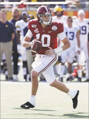  ?? John Raoux / Associated Press ?? Alabama quarterbac­k Mac Jones (10) scrambles as he looks for a receiver against Michigan during the first half of the Citrus Bowl on Wednesday.