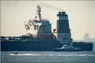  ?? AP PHOTO BY MARCOS MARENO ?? Royal Marine patrol vessel is seen beside the Grace 1 super tanker in the British territory of Gibraltar, Thursday, July 4, 2019. Authoritie­s in Gibraltar said they intercepte­d Thursday an Iranian supertanke­r believed to be breaching European Union sanctions by carrying a shipment of Tehran's crude oil to warravaged Syria.