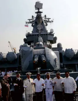  ?? —JOAN BONDOC ?? President Duterte (center), Philippine and Russian officials pose with clenched fists on the deck of the guided Russian missile cruiser Varyag which was docked at the Pier 15 in Manila on Friday.