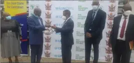  ?? ?? Local Government minister July Moyo (second from left) hands over a set of keys for one of the African Developmen­t Bank-donated cars to Zesa Holdings executive chairperso­n Sydney Gata