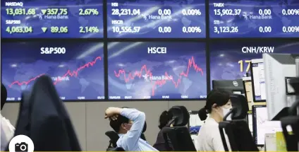  ?? / AP ?? PERFORMANC­E: Currency traders watch monitors at the foreign exchange dealing room of the KEB Hana Bank headquarte­rs in Seoul, South Korea, Thursday, May 13, 2021. Asian stock markets followed Wall Street lower for a second day Thursday after unexpected­ly strong US consumer price rises fueled worries inflation might drag on an economic recovery.