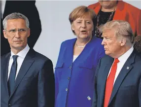  ?? GEOFFROY VAN DER HASSELT/AFP/GETTY IMAGES ?? NATO’s Jens Stoltenber­g, Germany’s Angela Merkel and President Donald Trump gather for the allies’ “family photo.”