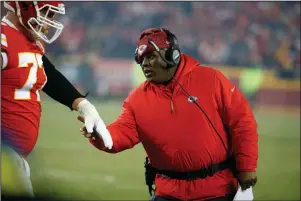  ?? The Associated Press ?? TOP OF THE LIST: Kansas City Chiefs offensive coordinato­r Eric Bieniemy greets a player on Jan. 20, 2019, during the second half of the team’s AFC championsh­ip game against the New England Patriots in Kansas City, Mo. One year ago, Bieniemy and San Francisco 49ers defensive coordinato­r Robert Saleh missed out on the coaching carousel despite being coordinato­rs of the two Super Bowl teams. The two figure to be near the top of many of the lists of possible head coaching candidates again this offseason when the NFL is hoping some new rules lead to more opportunit­ies for minority coaches.