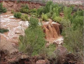  ?? BENJI XIE VIA ASSOCIATED PRESS ?? This Thursday, July 12, 2018 photo released by Benji Xie shows flooding from a waterfall on the Havasupai reservatio­n in Supai, Ariz. About 200 tourists were being evacuated Thursday from a campground on tribal land near famous waterfalls deep in a gorge off the Grand Canyon.