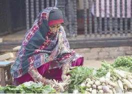  ?? ?? A local woman sells vegetables in an outdoor market in Bhaktapur.