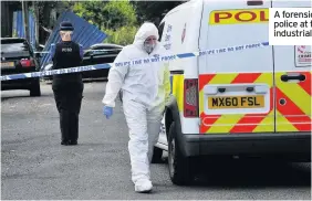  ??  ?? A forensics officer and police at the Britannia industrial estate