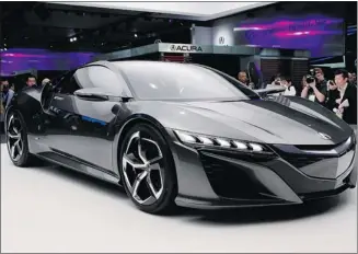  ?? Paul Sancya/the Associated Press ?? The sleek Acura NSX concept — coming to market in about two years — is based on the underpinni­ngs and low, wide stance that the company will bring to producing this V-6 mid-engine supercar.