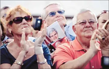  ?? Matt Rourke/associated Press ?? Supporters of Republican presidenti­al candidate Newt Gingrich applaud him at Wings Plus Restaurant in Coral Springs, Fla. Both Gingrich and rival Mitt Romney attacked President Barack Obama’s economic plans.