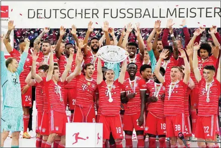  ?? ?? Bayern’s players celebrate with the championsh­ip trophy after the German Bundesliga soccer match between Bayern Munich and Stuttgart, at the Allianz Arena, in Munich, Germany. (AP)