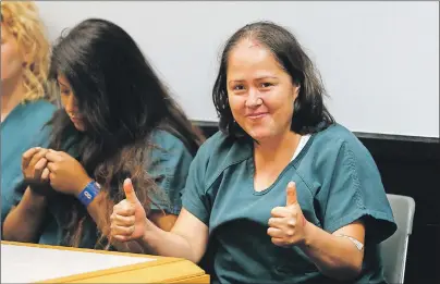  ?? AP PHOTO ?? Isabel Martinez gestures towards news cameras during her first court appearance Friday, in Lawrencevi­lle, Ga. Martinez is charged with killing four of her children and their father.