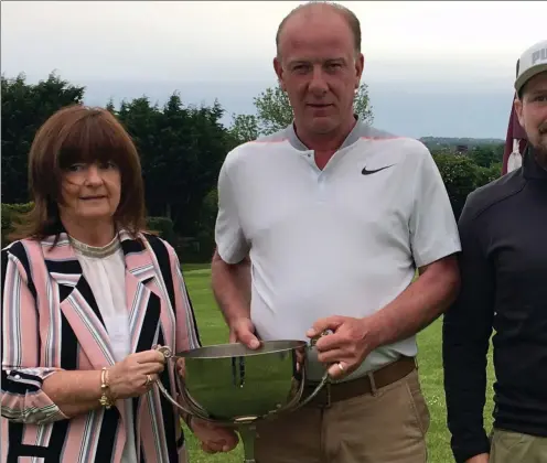  ??  ?? Dympna McKenna presents MacBride Pitch & Putt Club’s John McKenna Memorial Scratch Cup to overall winner George Beardsley, alongside sponsor